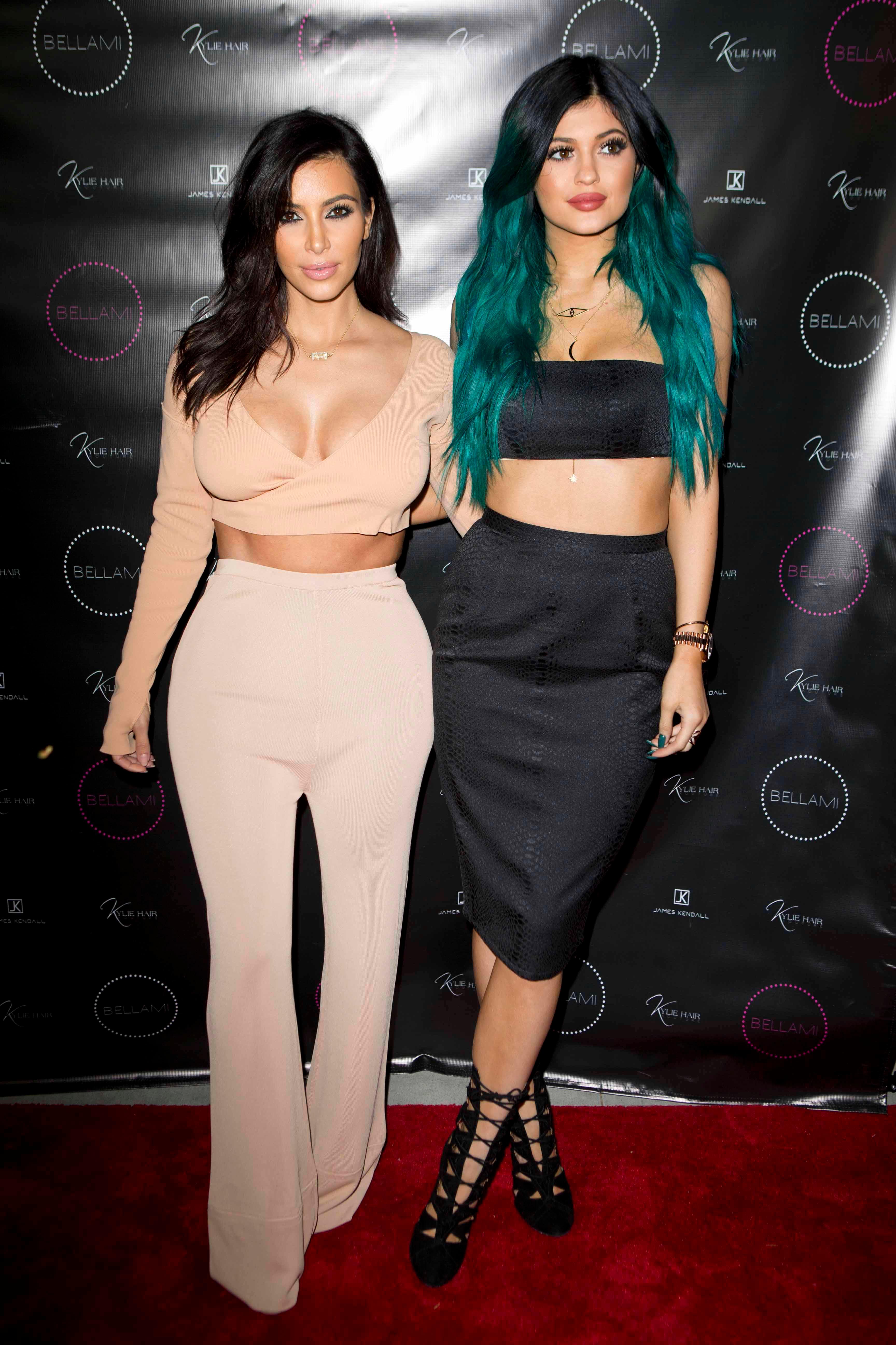 Kylie Jenner poses happily with her sisters on her big hair line extension night launch party LA