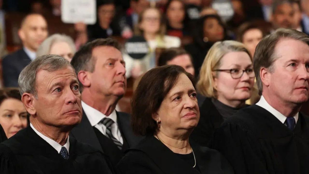 Image of Protesters pointed out John Roberts' controversial rulings through their demonstrations.