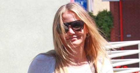 Cameron Diaz Covers Up in a baggy sweater and large bag while running errands on a Warm day