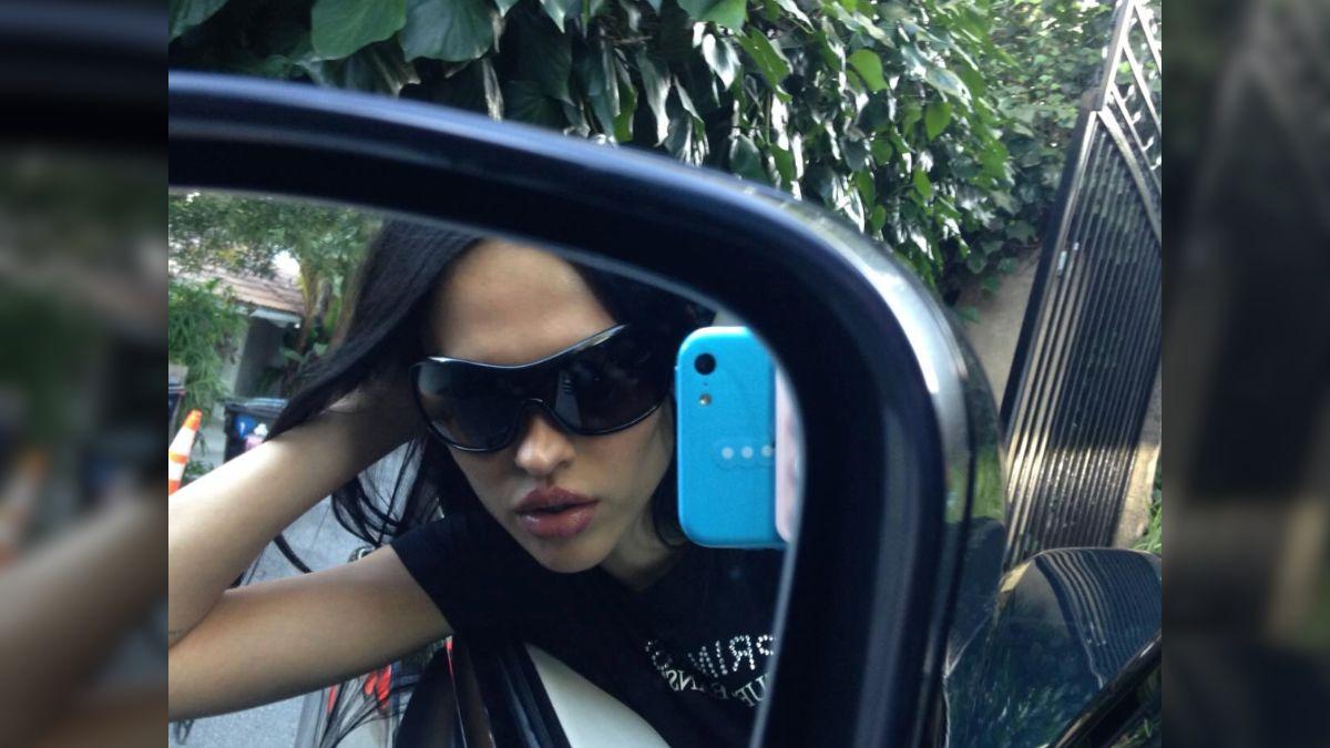 Image of Amelia Gray Hamlin posed provocatively in a car mirror.