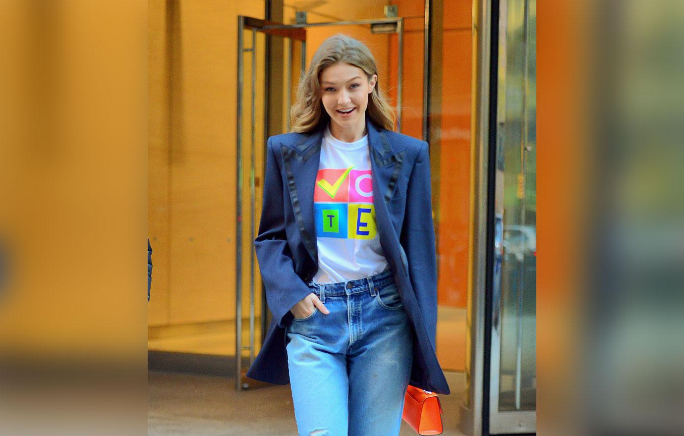 Gigi Hadid is all smiles showing off her VOTE t shirt as she leaves Victoria Secret fashion show fittings in NYC