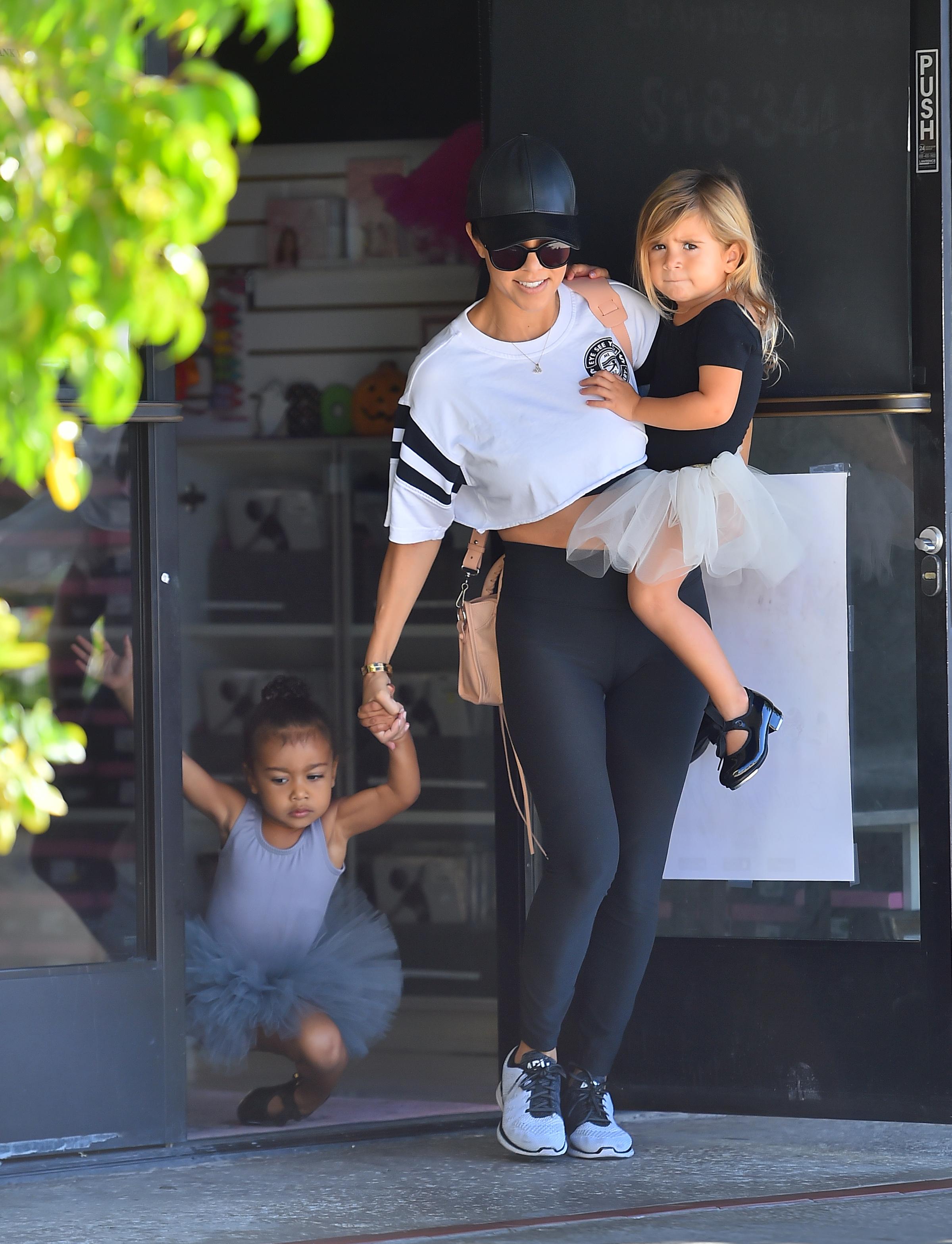 North West trips as she exits dance class with her aunt Kourtney Kardashian