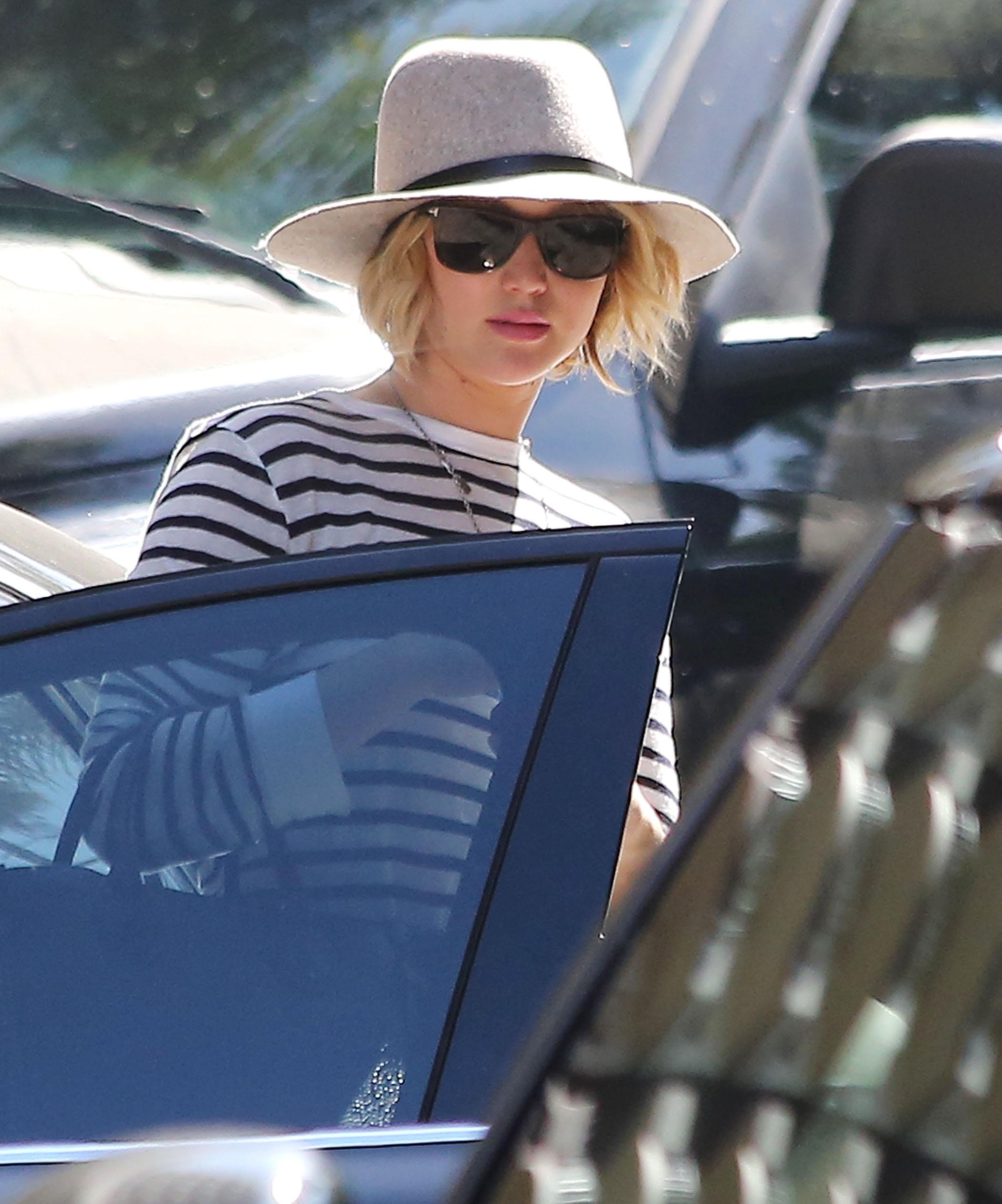 Jennifer Lawrence shows the photographers the middle finger through her new umbrella while visiting Rachel Zoe&#8217;s office in West Hollywood