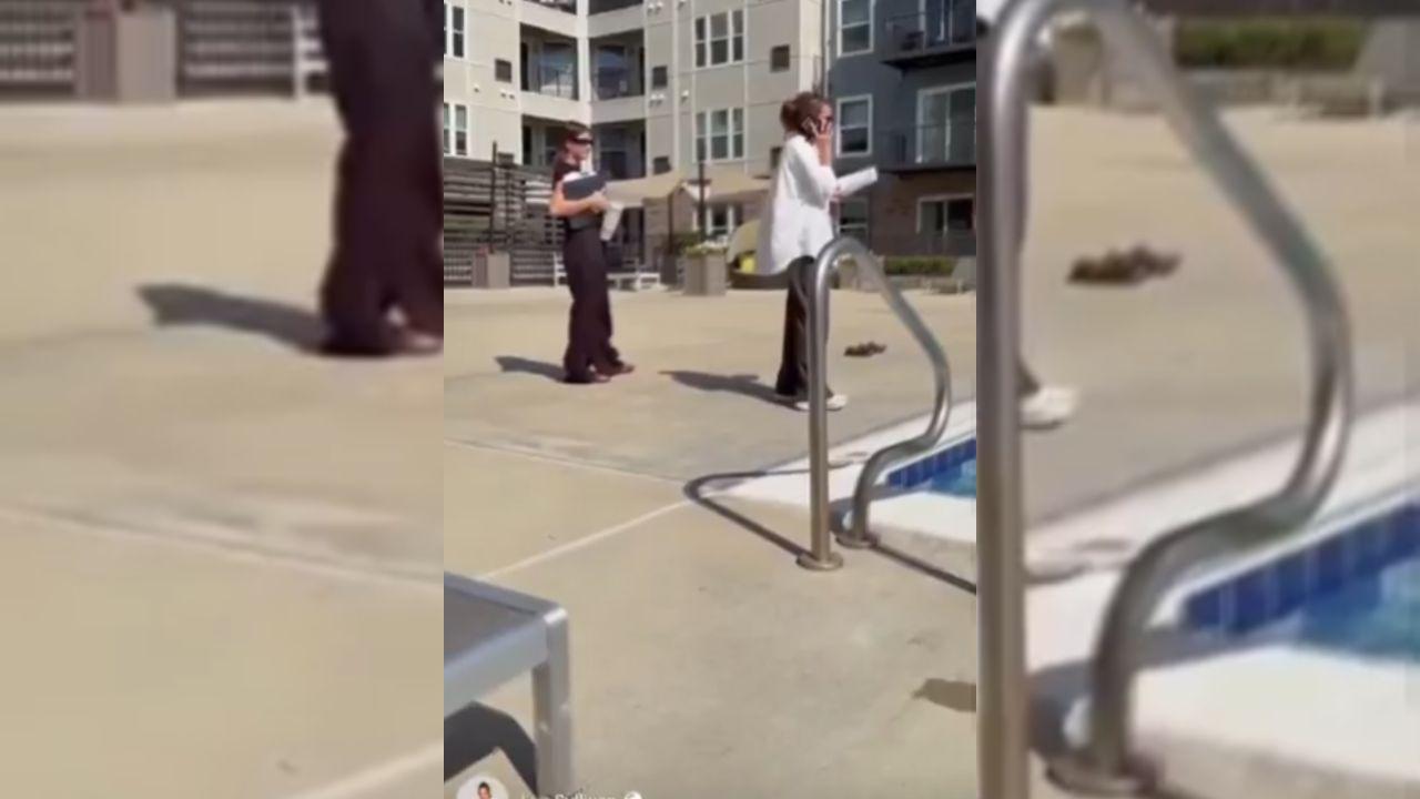 Image of a woman confronted a man and his children at a public pool and called the police on them while they were relaxing outside.