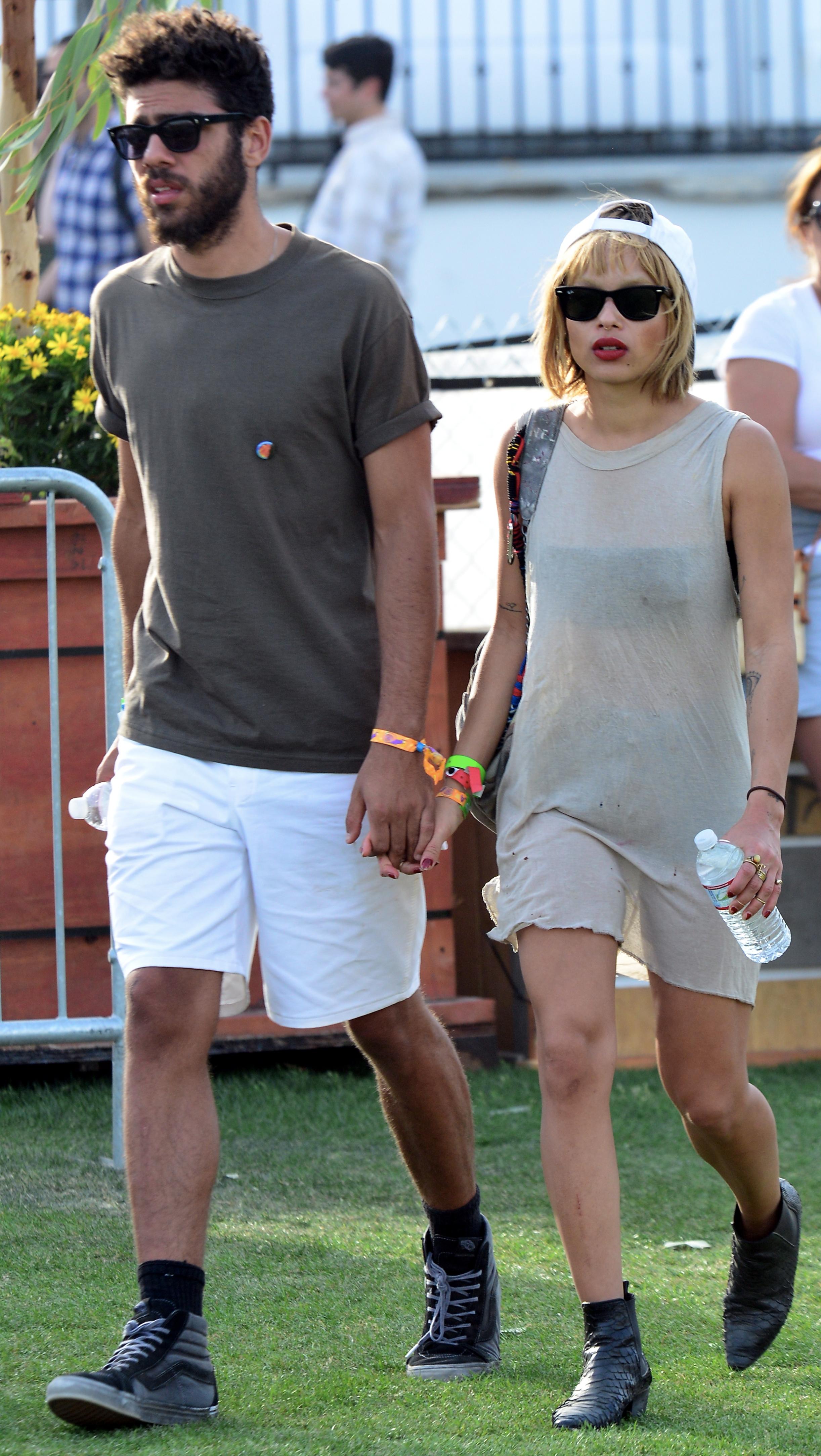 Actress Zoe Kravitz, daughter of Lenny Kravitz and Lisa Bonet, walks with her rumored new boyfriend Noah Becker during day 2 of the Coachella Music Festival in Indio, CA