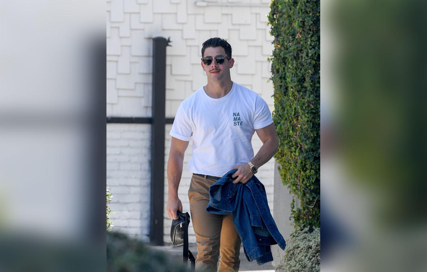 EXCLUSIVE: Nick Jonas sports a mustache as he arrives at a studio