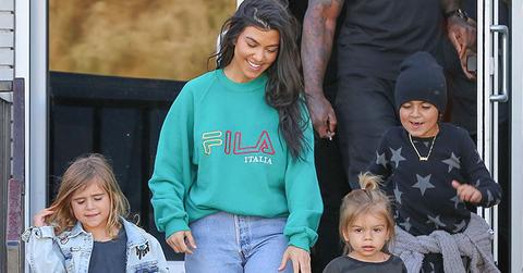 Kourtney Kardashian grins from ear to ear as she leaves the bowling alley with her family
