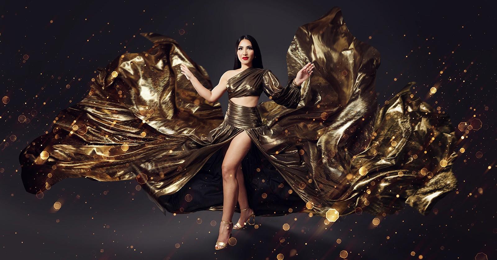 Dr. Neda Hovaizi poses in a flowing gold gown.