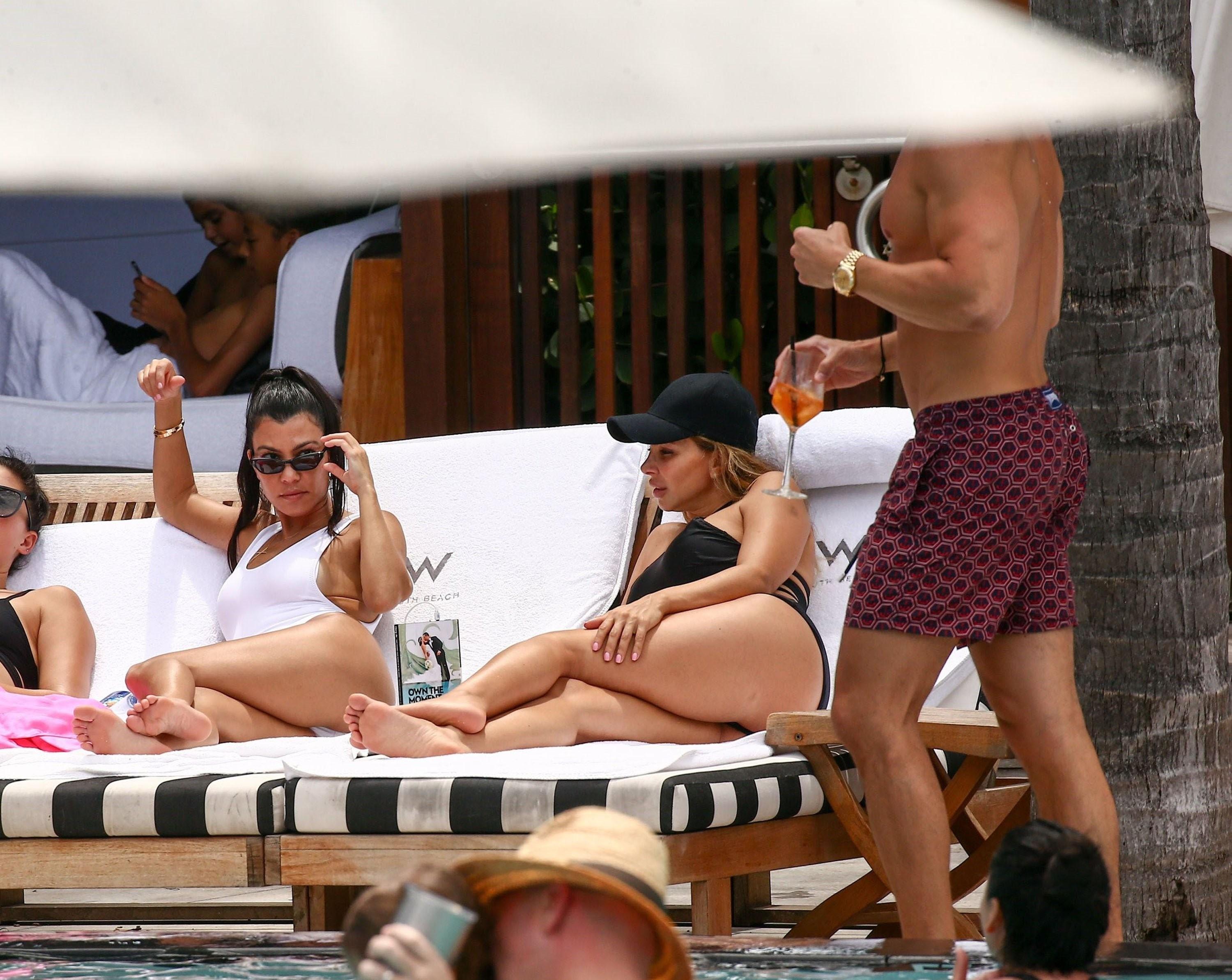 Kourtney Kardashian checks out a mystery guy by the pool in Miami