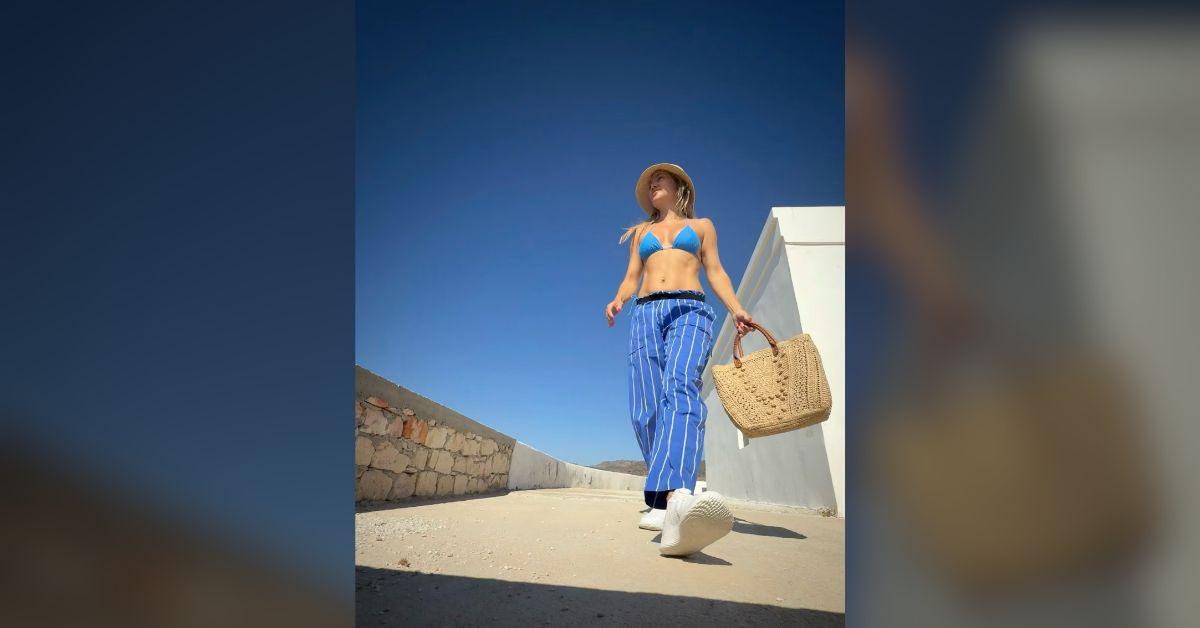 Image of Kate Hudson dressed in head-to-toe blue beachwear.