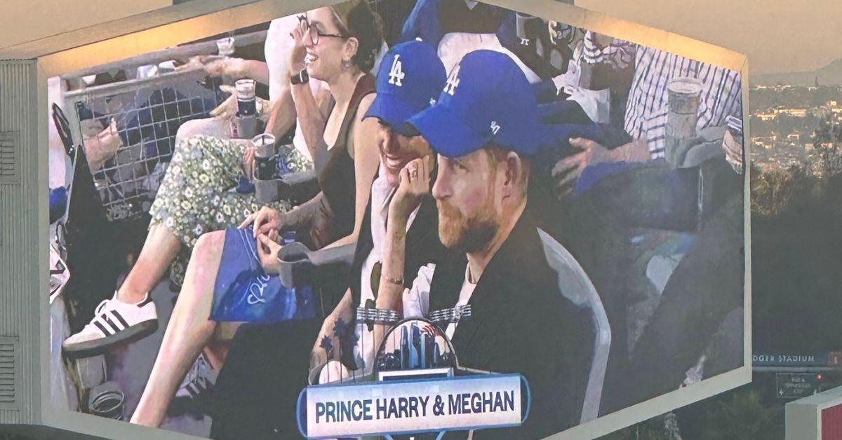 image of The couple wore matching Dodgers hats.
