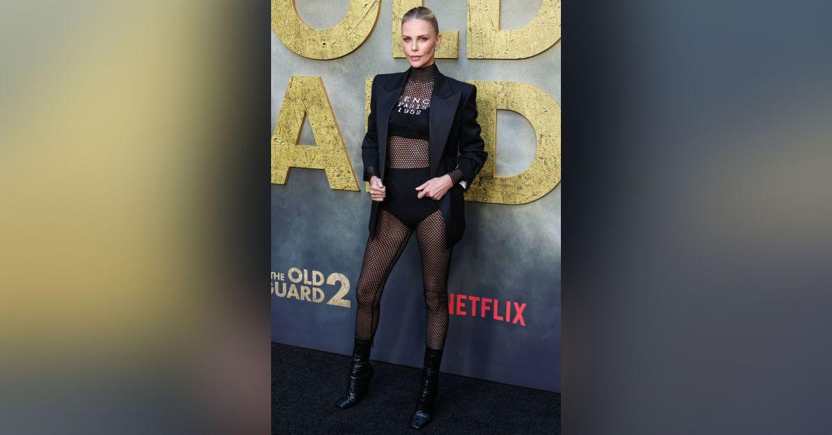 charlize theron sizzles fishnet tights hot pants old guard premiere photos