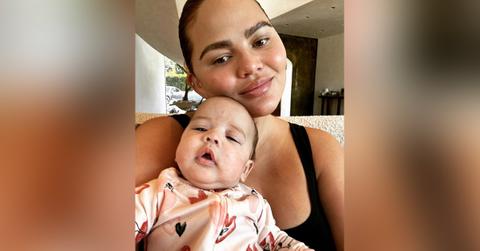 chrissy teigen cuddles daughter esti photos