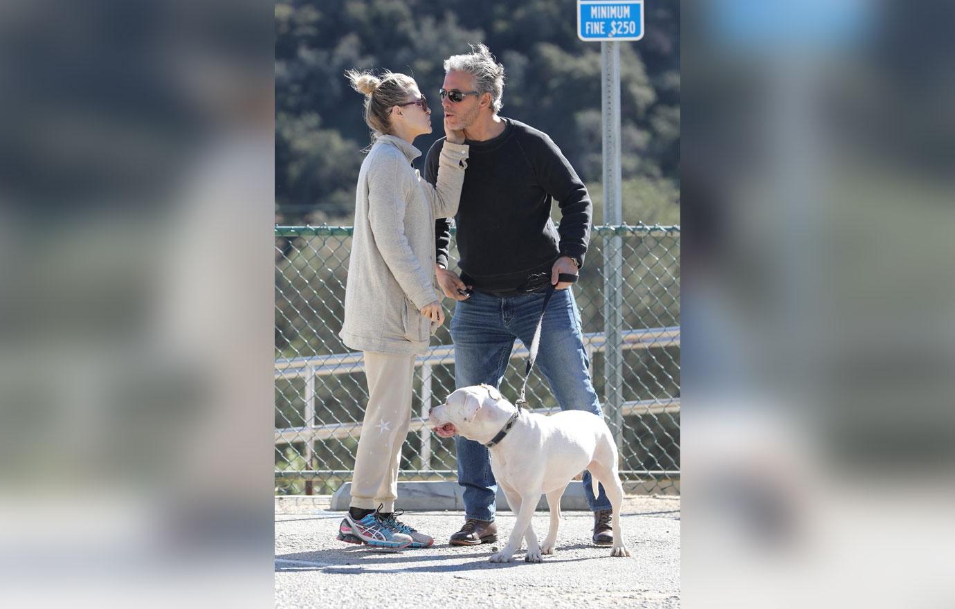 *EXCLUSIVE* Joanna Krupa packs on the PDA on an outing to the dog park with a mystery man