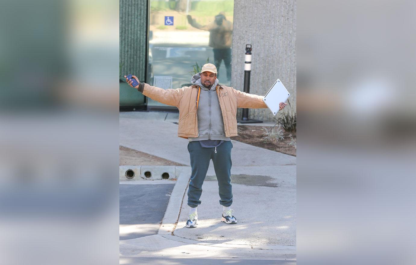 Kanye West greets our shutterbugs with open arms!