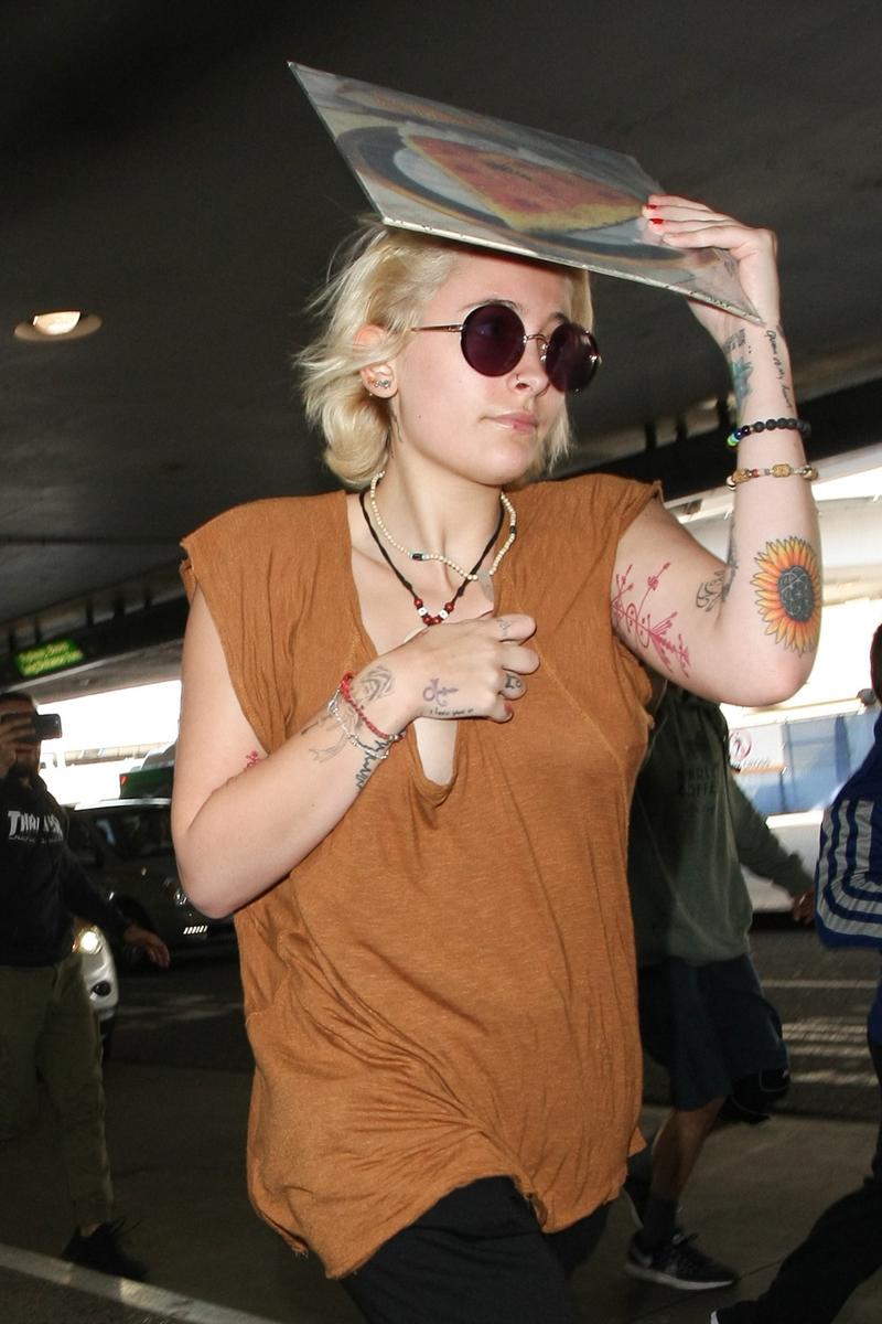 Paris Jackson gets camera shy as she arrives at LAX