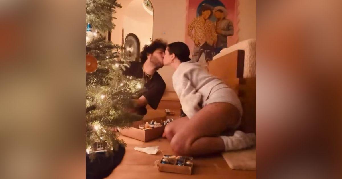 image of The couple decorated their tree while sitting on the floor.