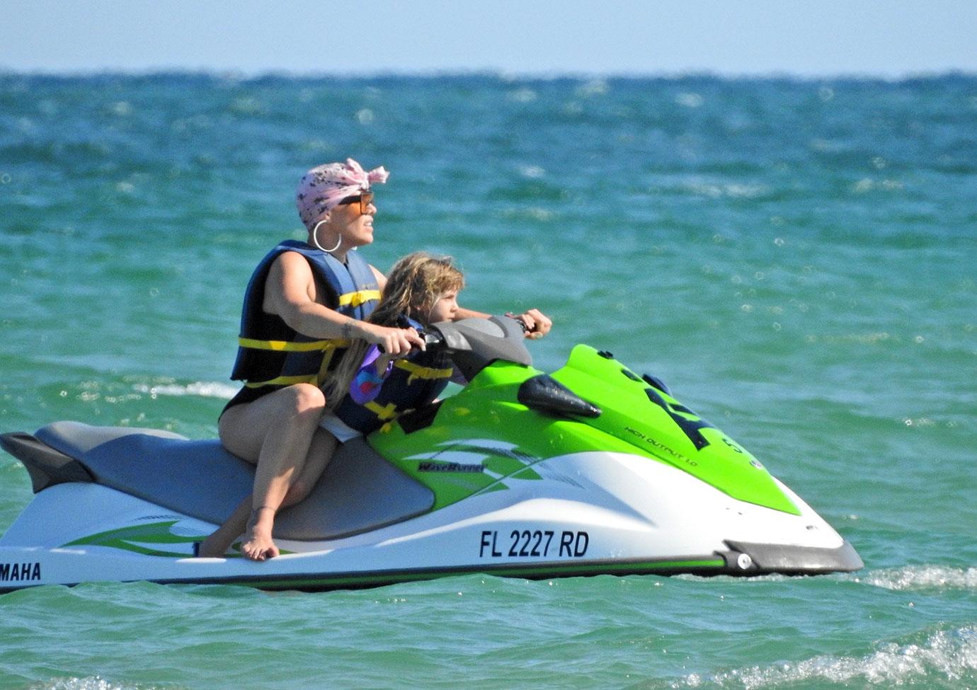 Pink and her adorable family ride some Jet Skis on the Beach in Florida