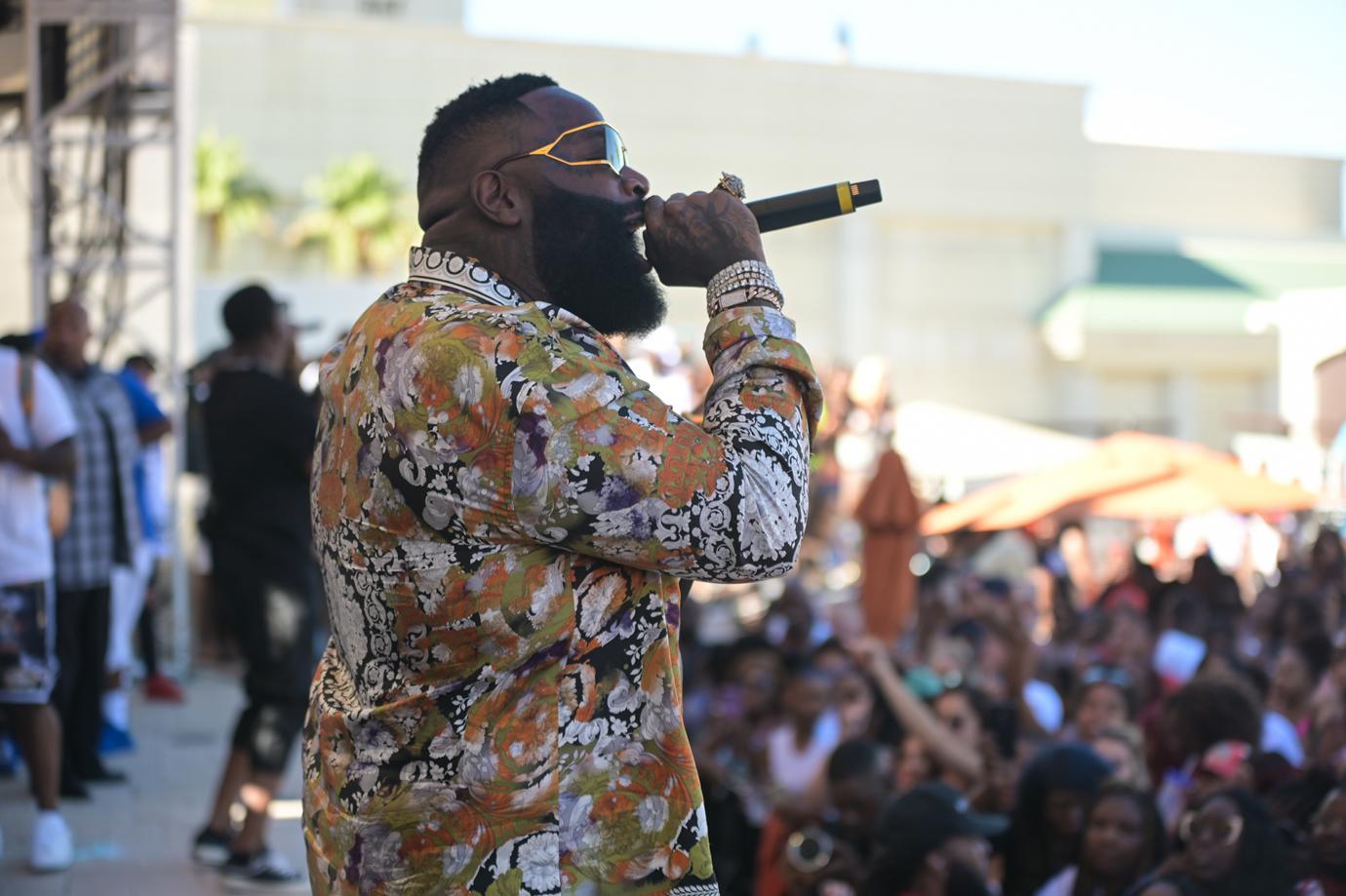 Rick Ross Performs on Stage Wearing a Colorful Print Shirt and Sunglasses