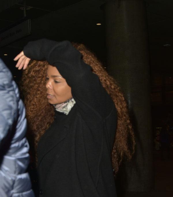 Janet jackson looks annoyed hiding neck scarf 01