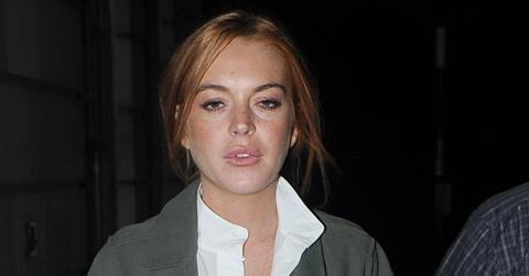 INF – Lindsay Lohan Wears A Long Coat Over A White Dress & Knee High Boots