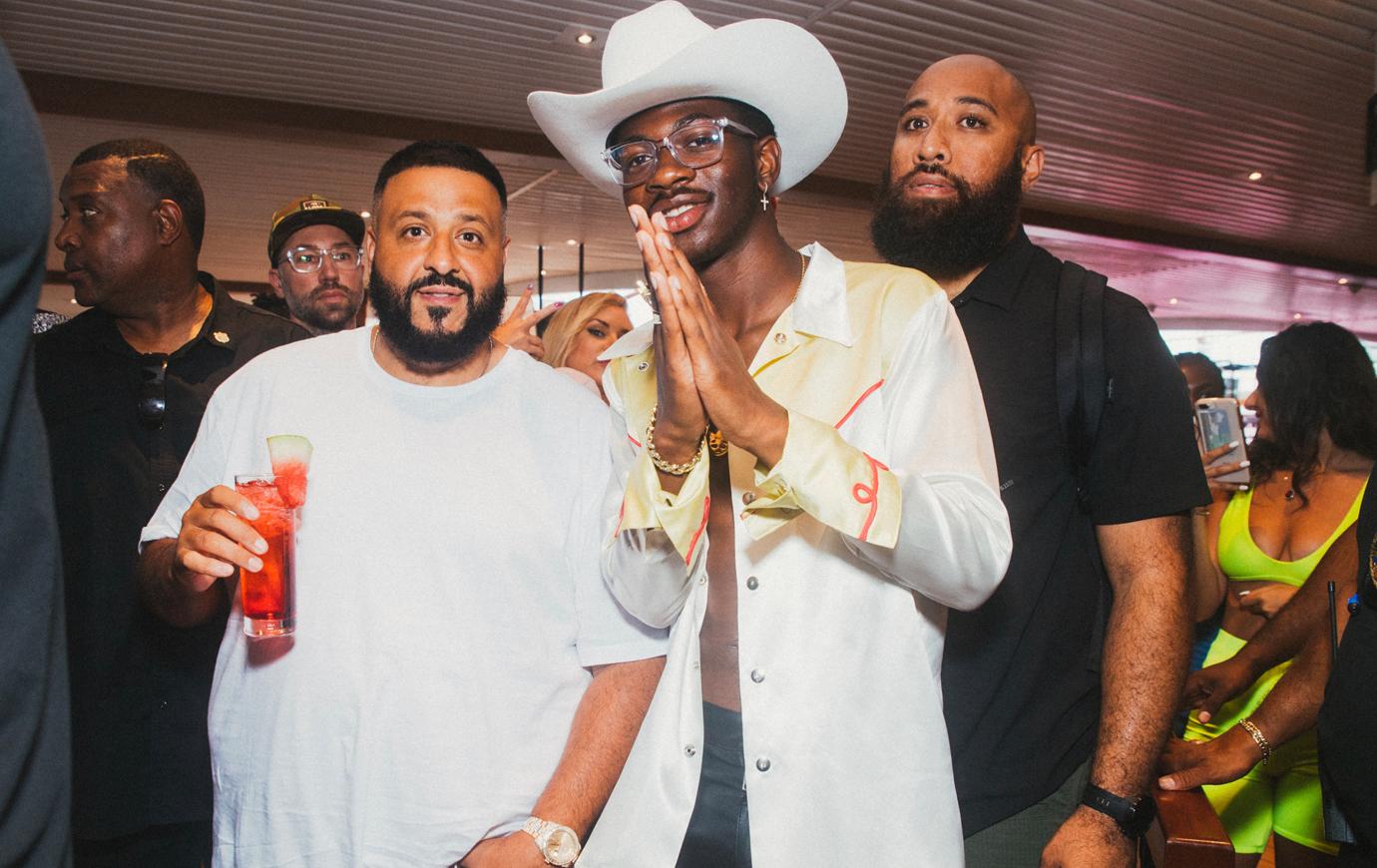 Lil Nas X and DJ Kgaled Pose Smiling Wearing White At Event