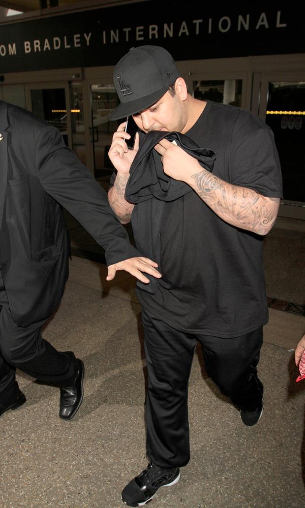 Rob Kardashian skips his sister, Kim Kardashian&#8217;s wedding as he&#8217;s seen landing at LAX on the day his sister is supposed to marry Kanye West in Paris, France.