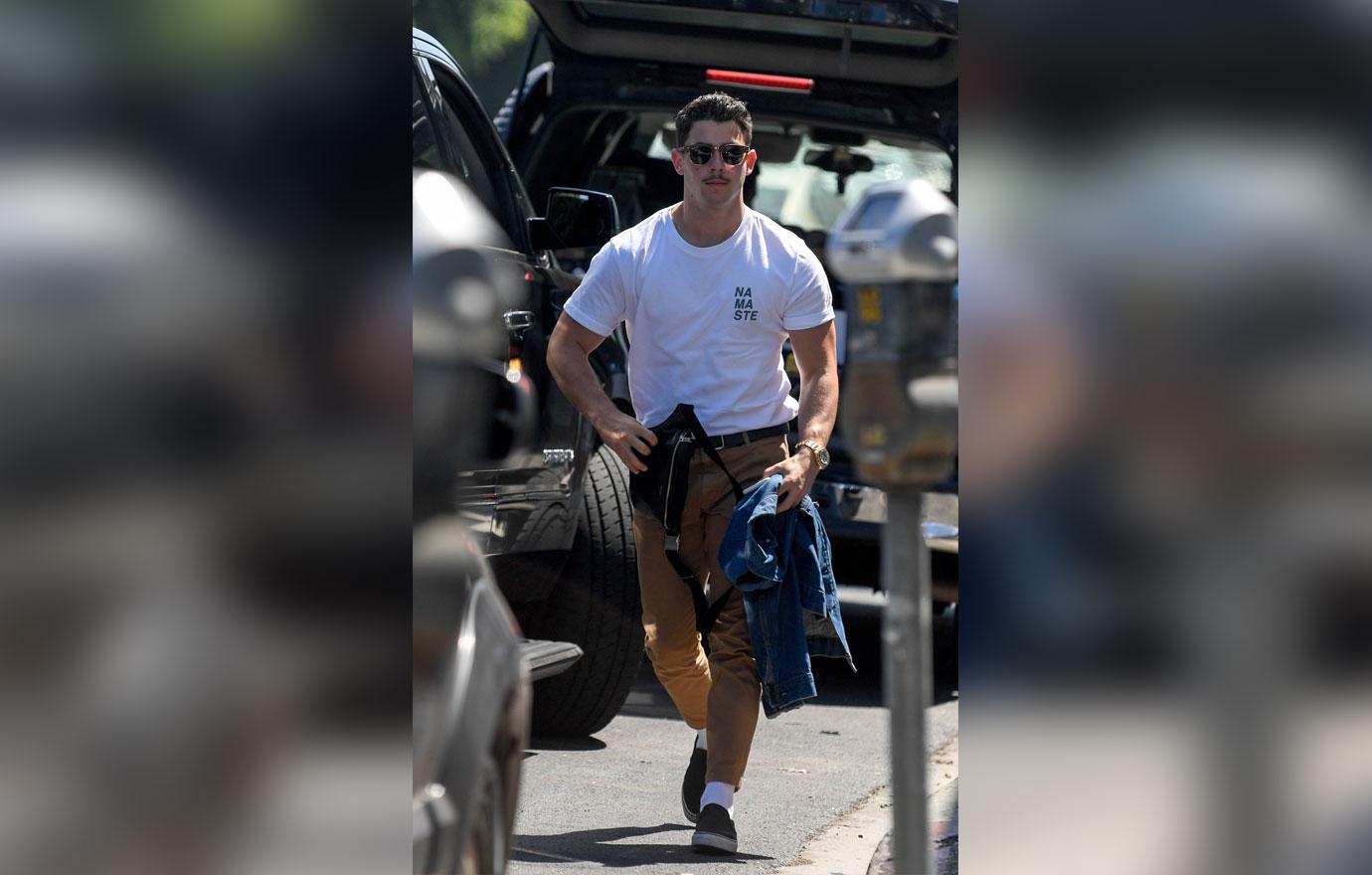 EXCLUSIVE: Nick Jonas sports a mustache as he arrives at a studio