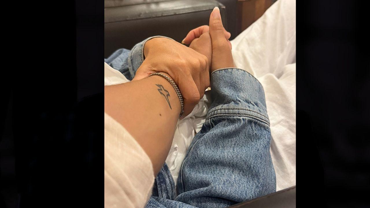 Image of Danny Ramirez and Jessica Alba's hands.