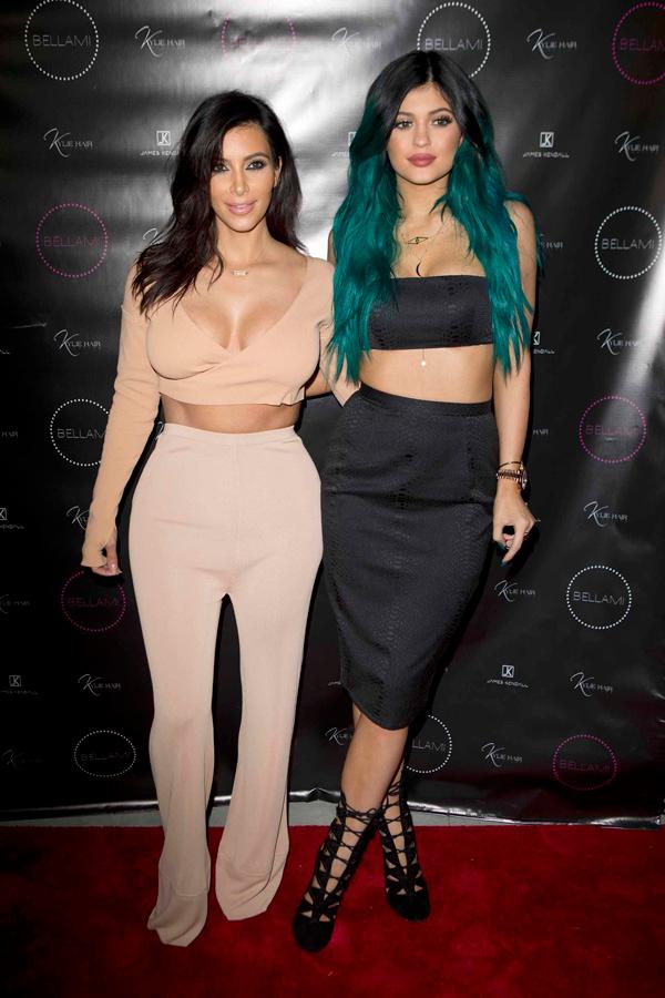 Kylie Jenner poses happily with her sisters on her big hair line extension night launch party LA