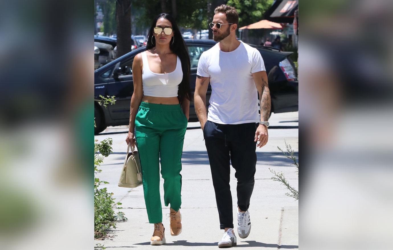 Nikki Bella In Green Jeans Walking With Artem Chigvintsev