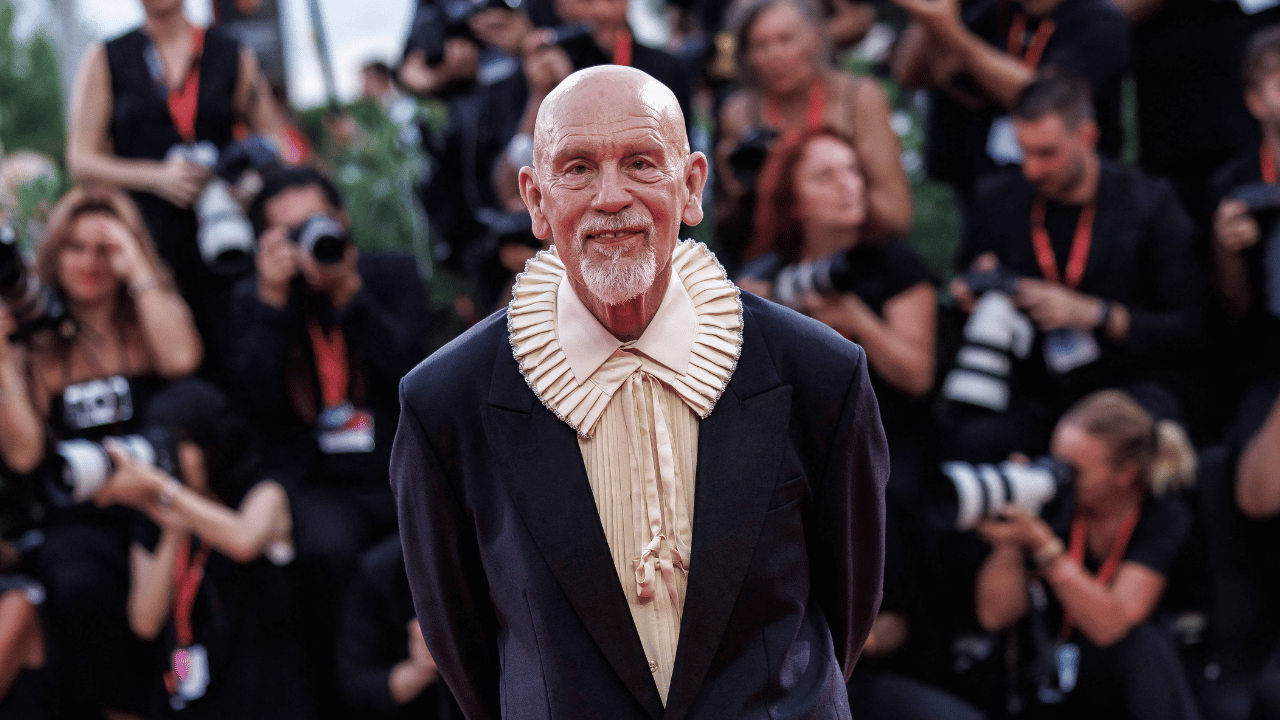 Image of John Malkovich put a stylish twist on black-tie dressing in a Dior suit.