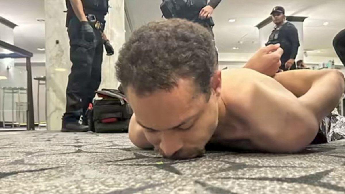 Image of Authorities detained a suspect after the shooting. 