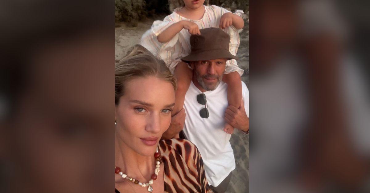Image of Rosie Huntington-Whiteley posed with her daughter and partner at the beach.