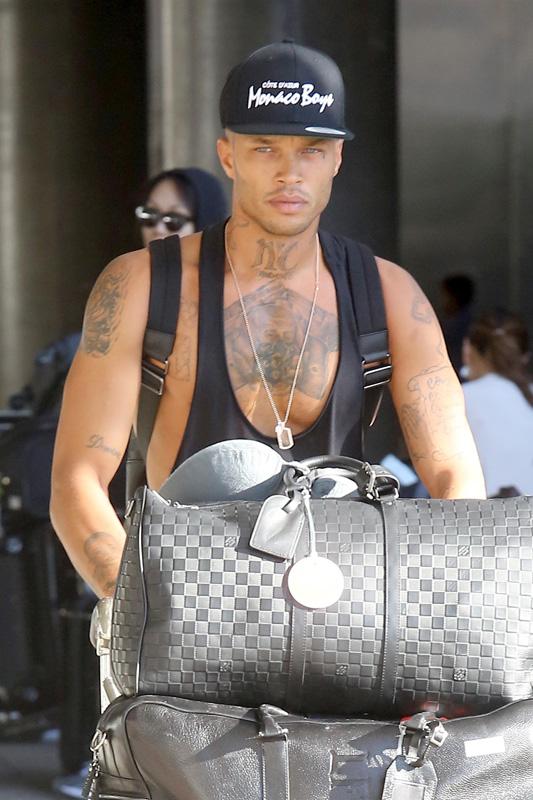 Jeremy Meeks hauls a huge cart of luggage through LAX