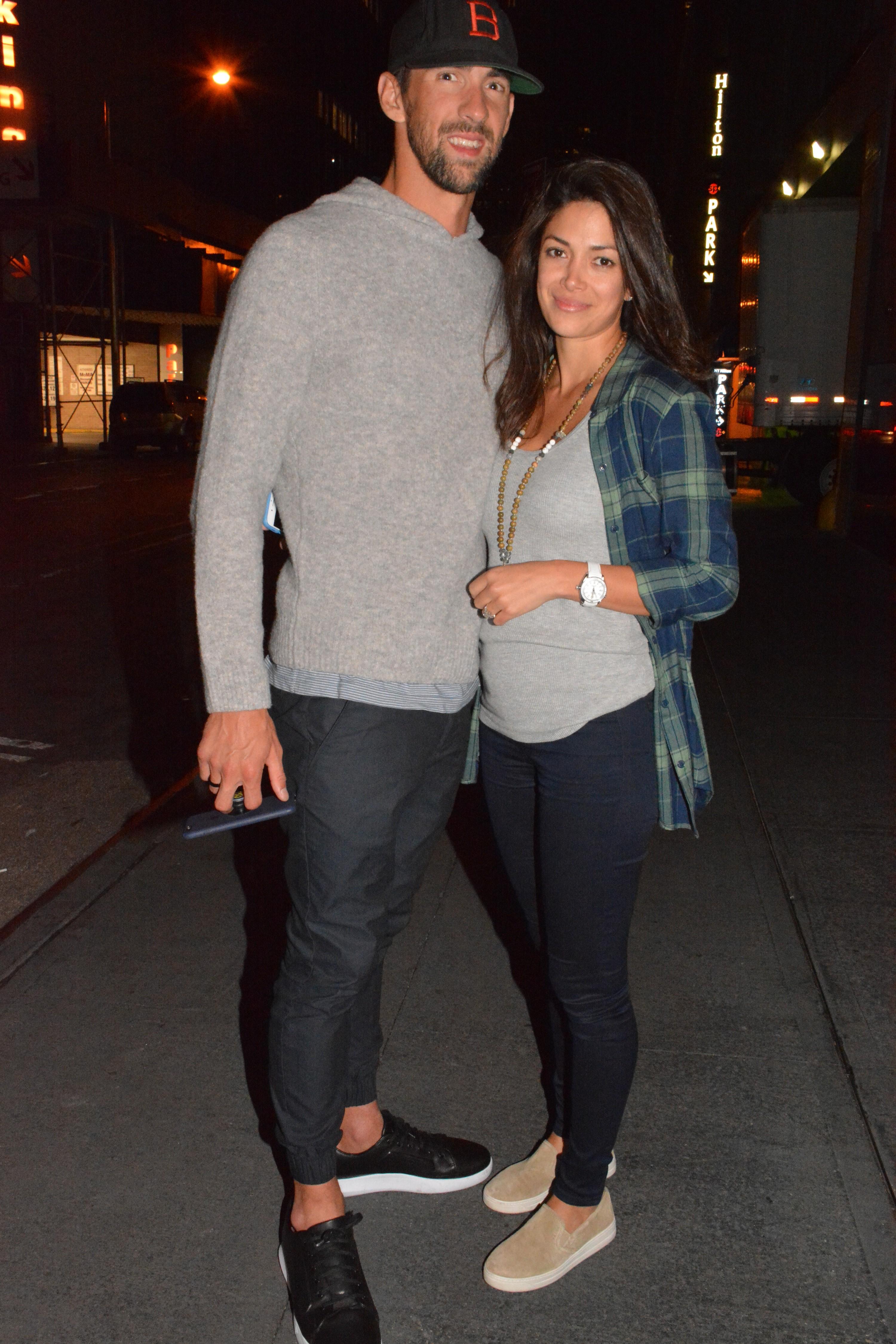 EXCLUSIVE: Olympian Michael Phelps and fiancee Nicole Johnson enjoy a date night walking around New York City