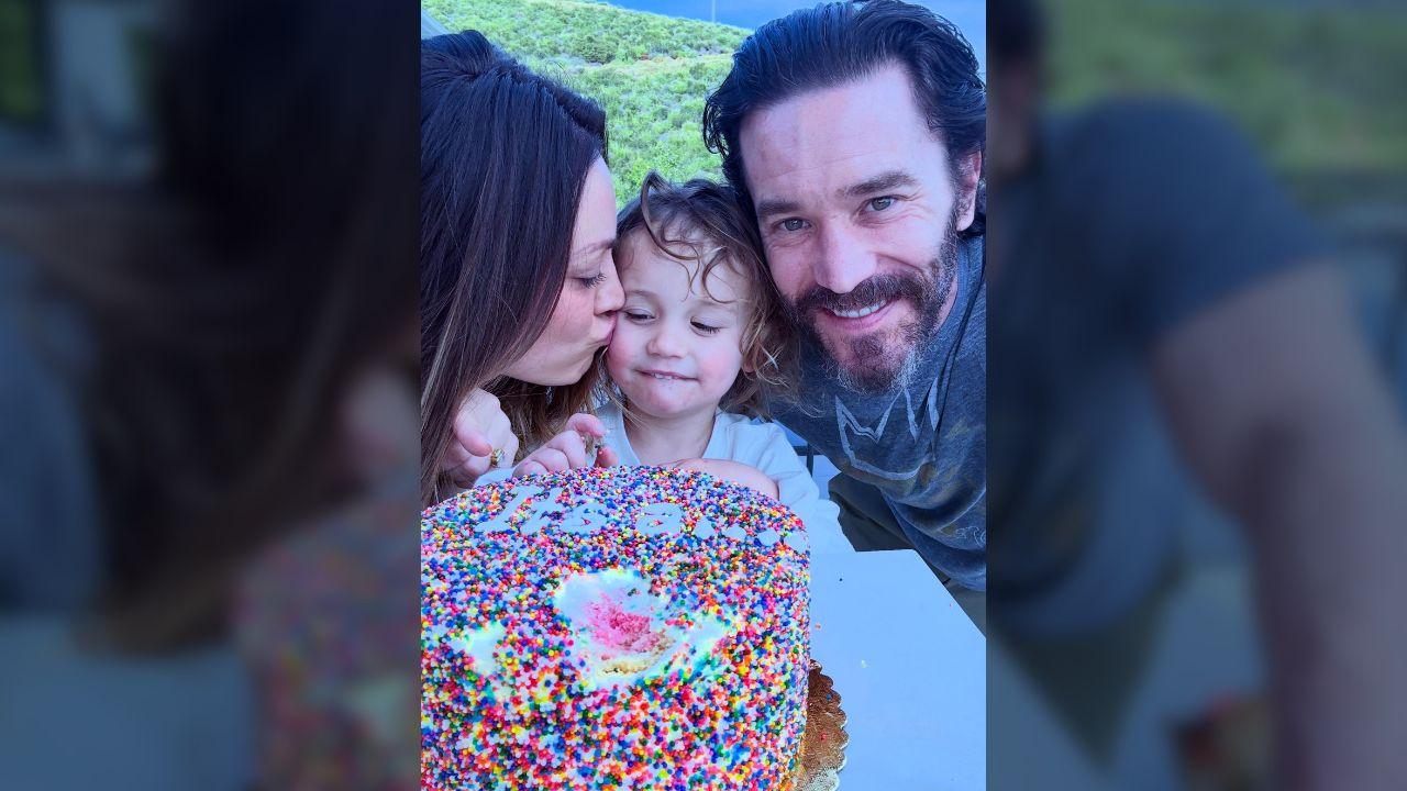 image of Cuoco announced her second pregnancy with Pelphrey in a family photo featuring Matilda and a rainbow sprinkle-covered cake.