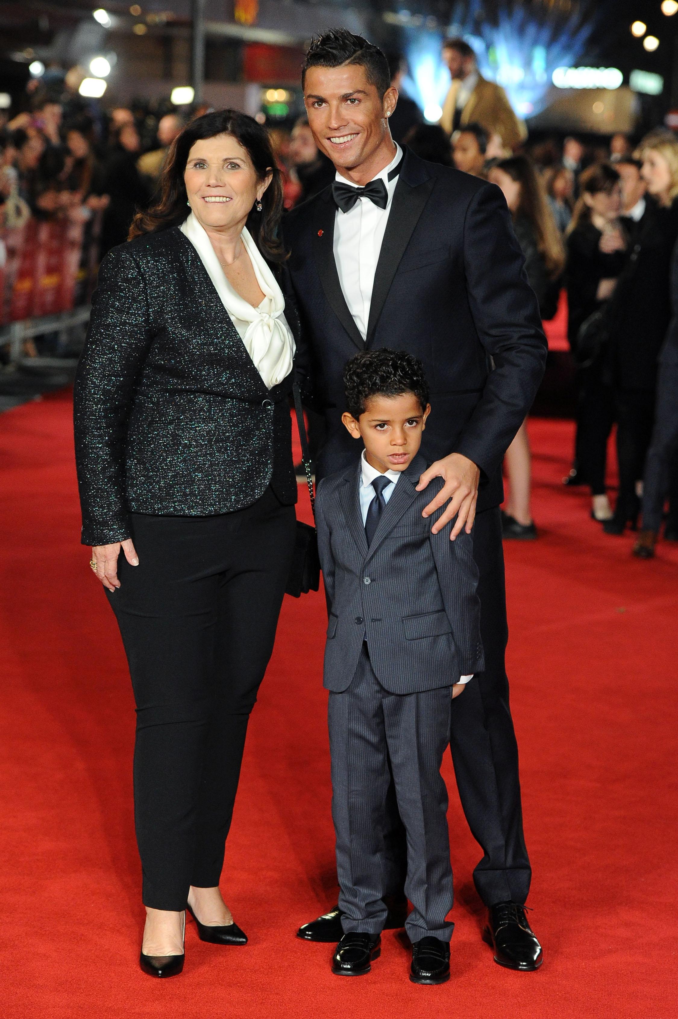 Cristiano Ronaldo kisses his son and poses with Sir Alex Ferguson and several guests at the world premiere of &#8216;Ronaldo&#8217; in London