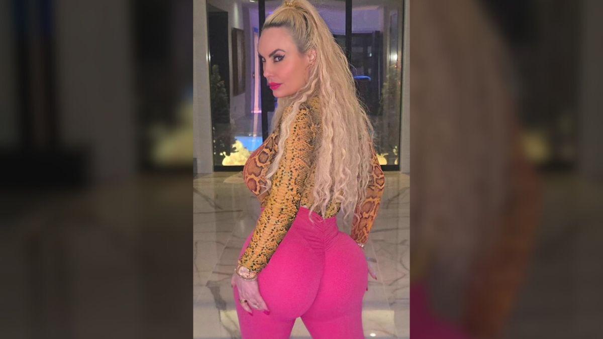 image of She styled the bold look with a snakeskin-print long-sleeve top and glam makeup.