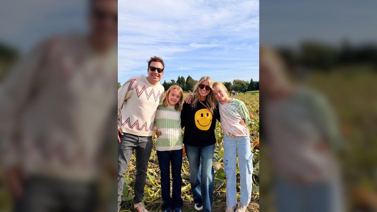 Photo of The sweet family posed for a picture at the pumpkin farm.
