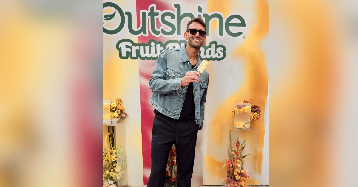 image of Carl Radke, of Bravo’s 'Summer House,' enjoying a new Outshine Fruit Blend Bar at the Outshine Savor The Summer Pop Up in NYC, where his brand Soft Bar served guests soft NA cocktails.