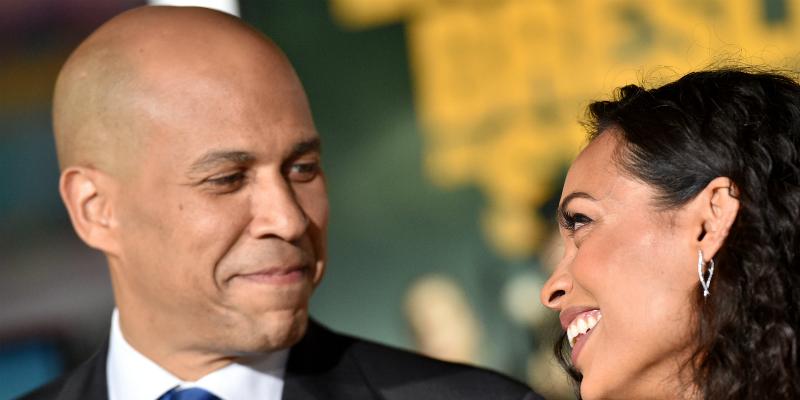 Corey Booker smiles at Rosario Dawon on the red carpet - and she smiles back.