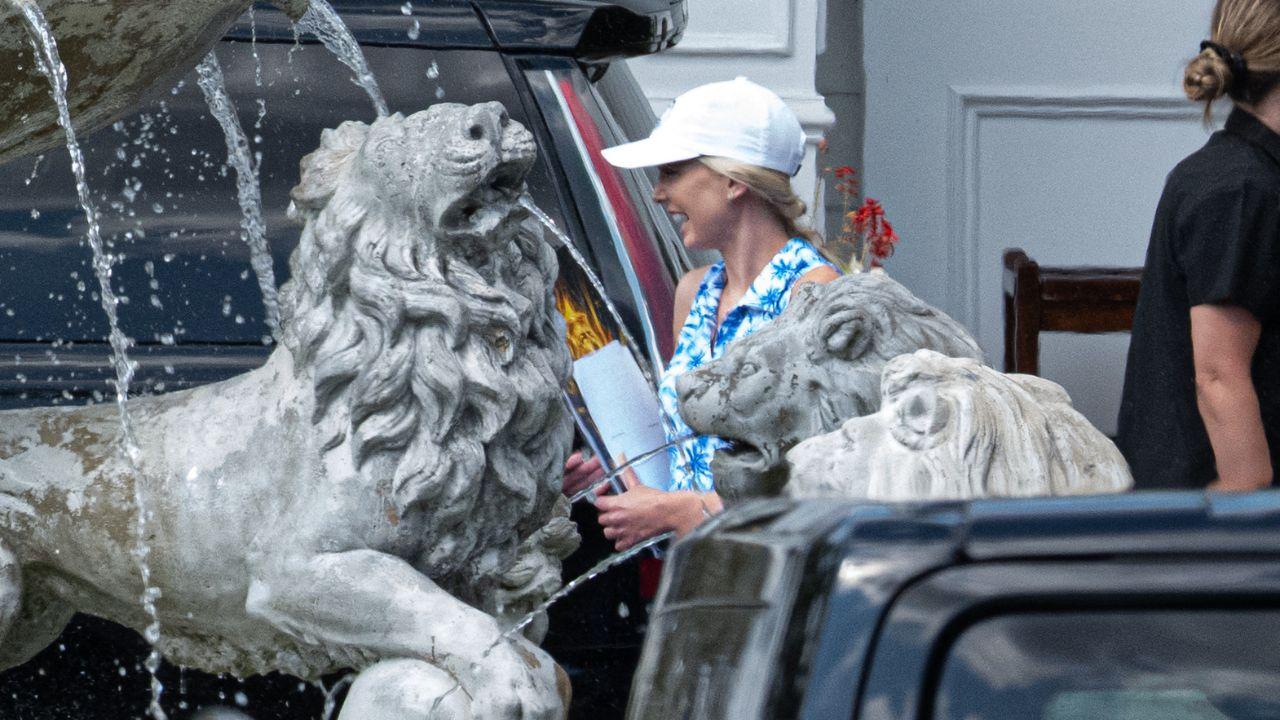 Image of Natalie Harp was later photographed seated behind Donald Trump at the golf club restaurant with a tablet.