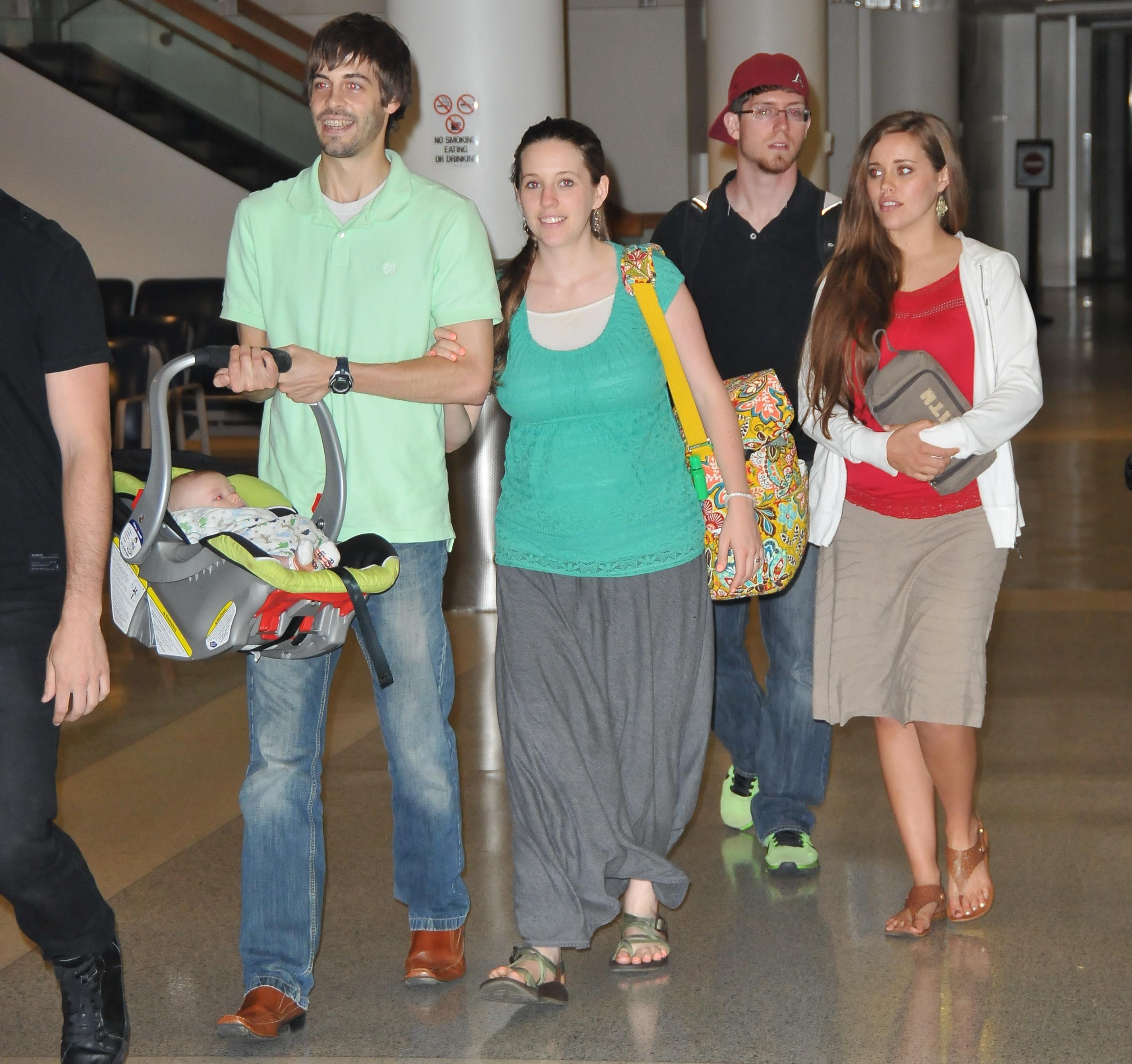 EXCLUSIVE: Jill and Jessa Duggar spotted Akron Airport with their husbands