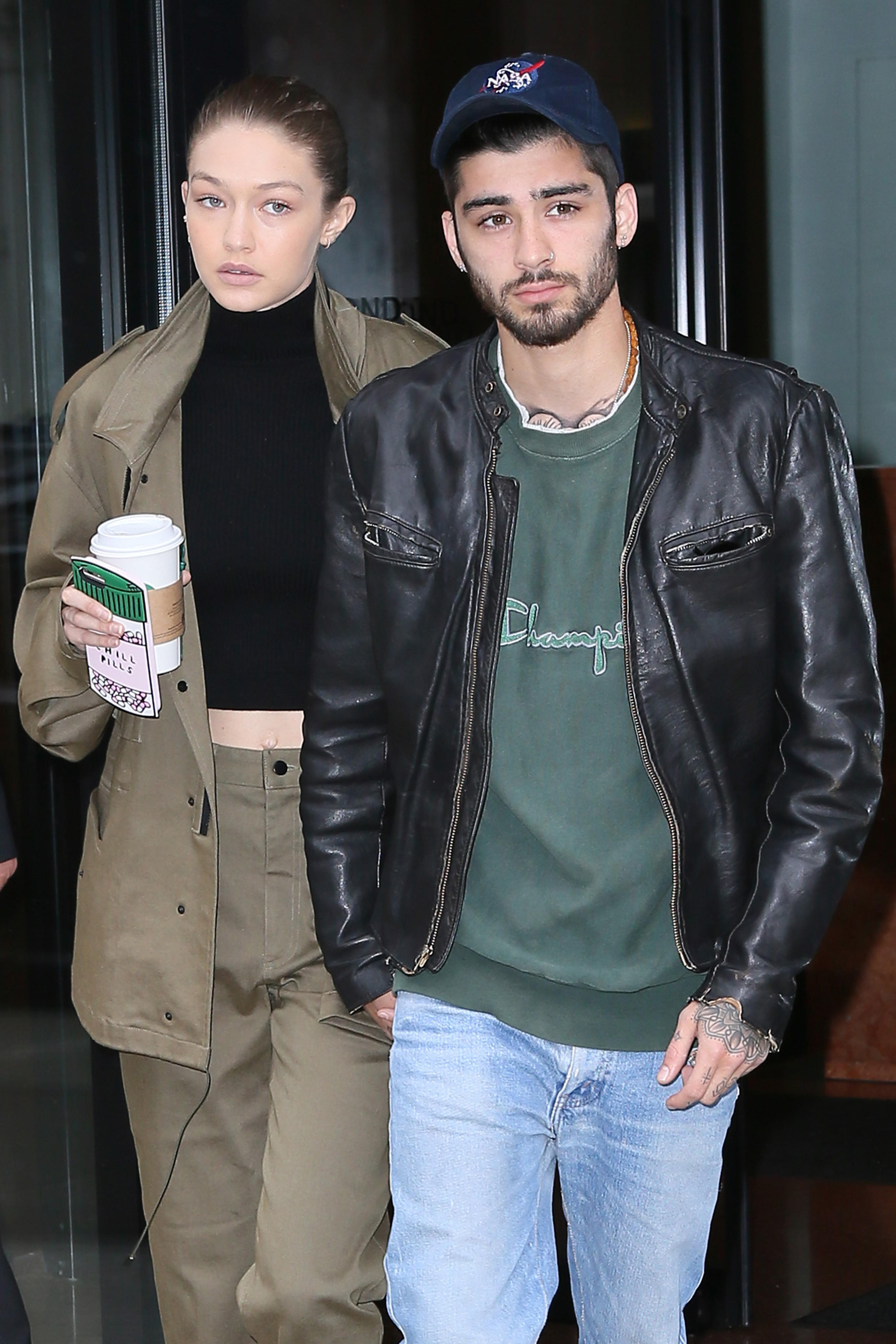 Gigi Hadid and Zayn Malik hold hands as they leave their apartment together