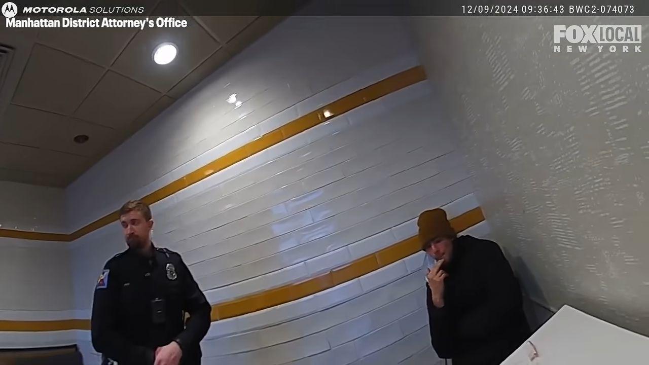 Image of Luigi Mangione and officer