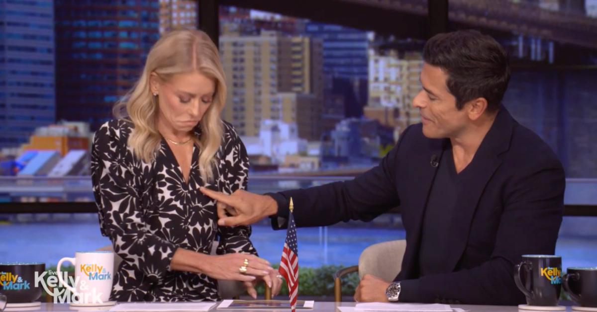 Image of Kelly Ripa had to 'reach down deep' into her cleavage to retrieve her mic.