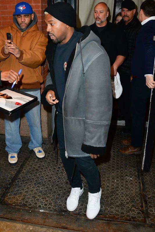 Kanye West steps out of his apartment before his fashion show starts