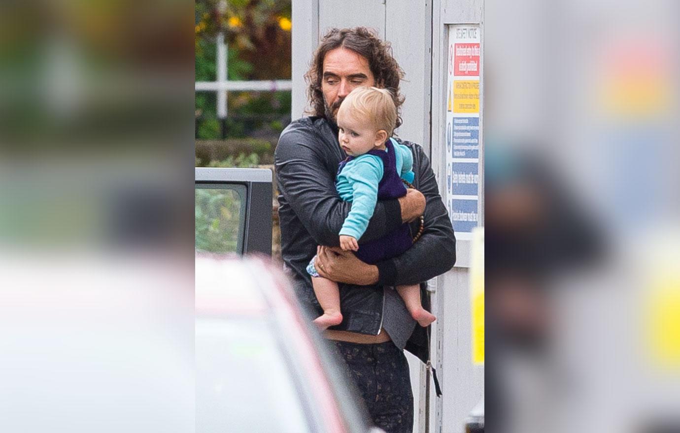 Russell Brand Cradles Precious Daughter During Stroll With Wife