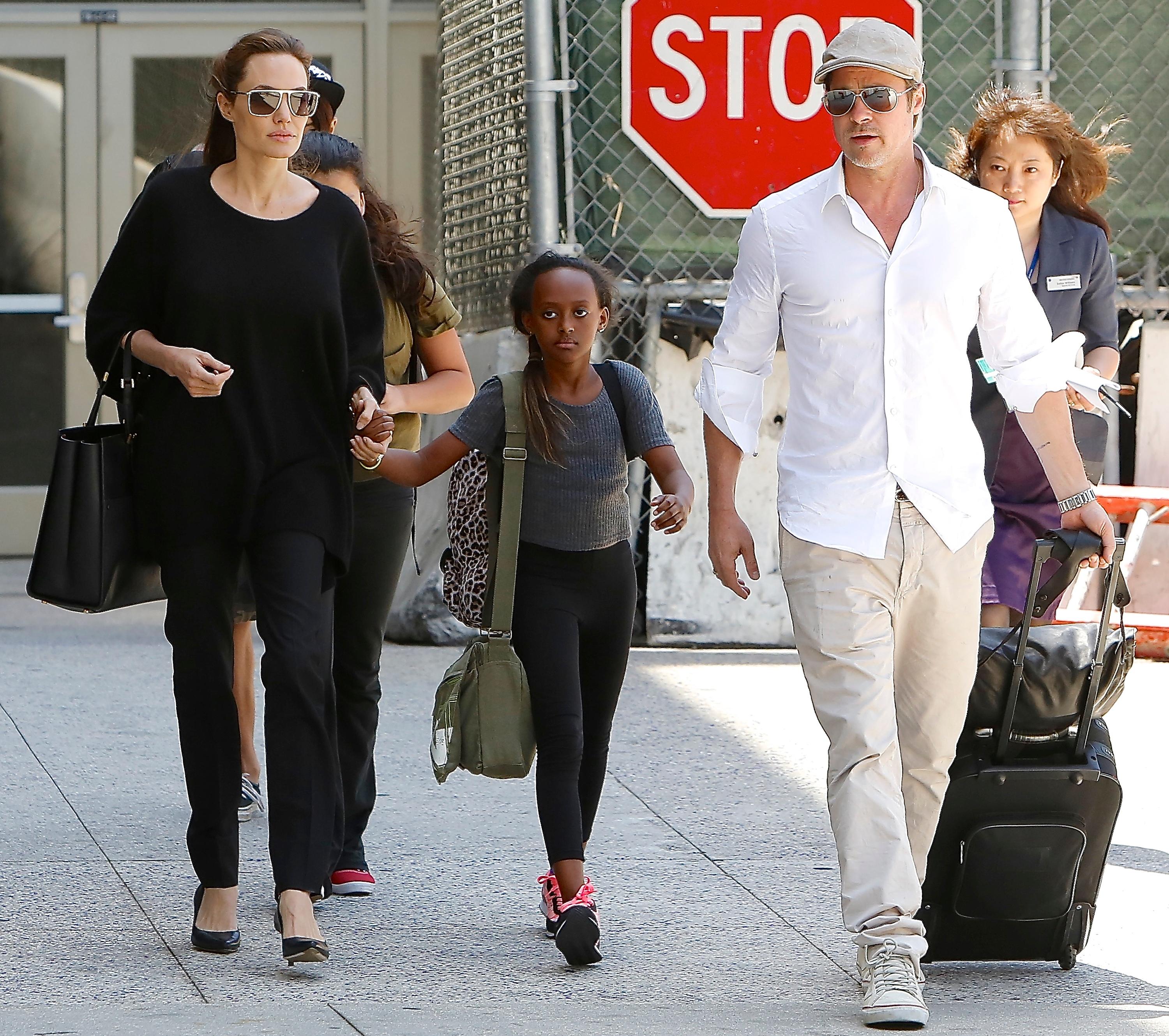 Angelina Jolie, Brad Pitt, Maddox and Zahara are seen at LAX Airport, CA.